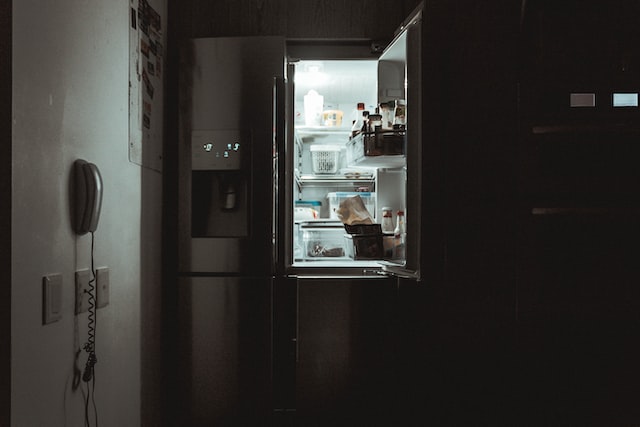 open fridge in darkness